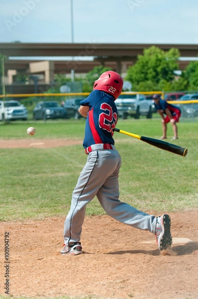 Fototapeta Youth baseball player swinging bat