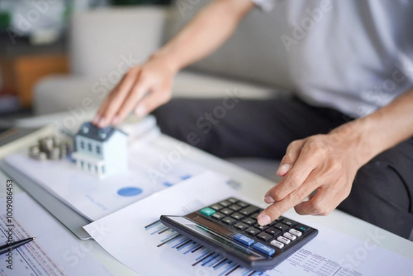 Fototapeta Man planning to save money for buy a new home in future