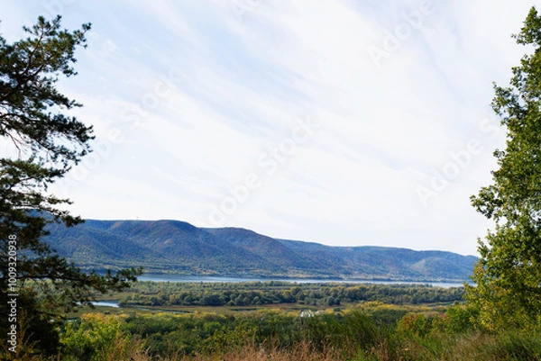 Obraz mountain landscape with blue sky. Autumn landscape with dense trees and vibrant foliage under a clear blue sky. from a bird's eye view. Scene of unspoiled nature.