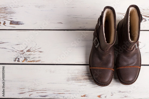 Obraz Winter boots on a wooden boards.