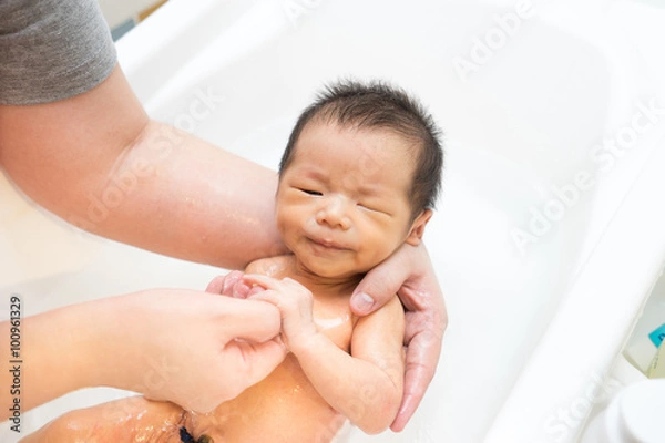 Fototapeta Asian newborn baby having a bath