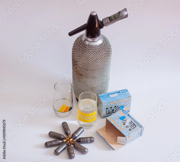 Fototapeta Vintage retro CO2 Siphon Dispensder bottle and CO2 charger canister. Soda Stream ancestor.