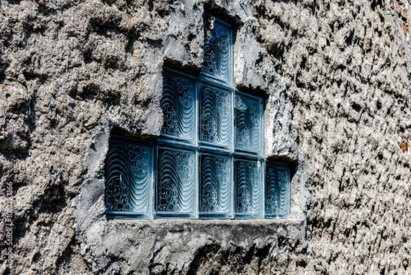 Obraz Textured wall with a geometric arrangement of decorative glass blocks, creating a unique pattern that blends rustic and modern design elements, perfect for architectural use