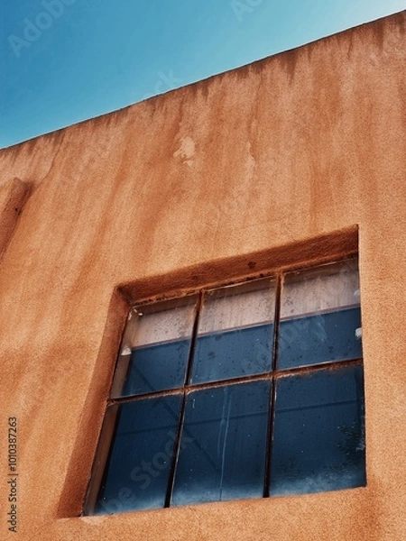 Obraz Window in adobe building against sky