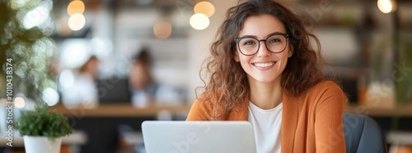 Fototapeta beautiful smiling business woman professional working on laptop computer device sitting at desk in office.