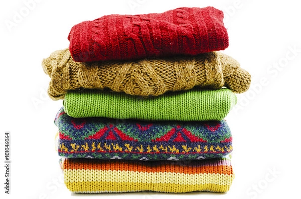 Obraz Stack of various sweaters. Winter style. Isolated on white background 