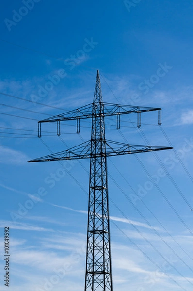 Fototapeta  high-voltage electricity pylons against blue sky 
