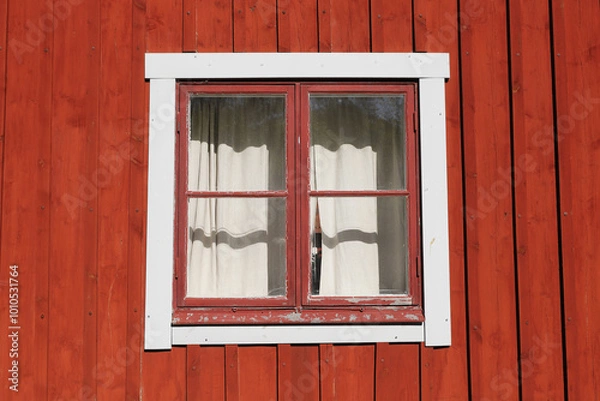 Obraz A red  wooden wall with an old window with curtain.