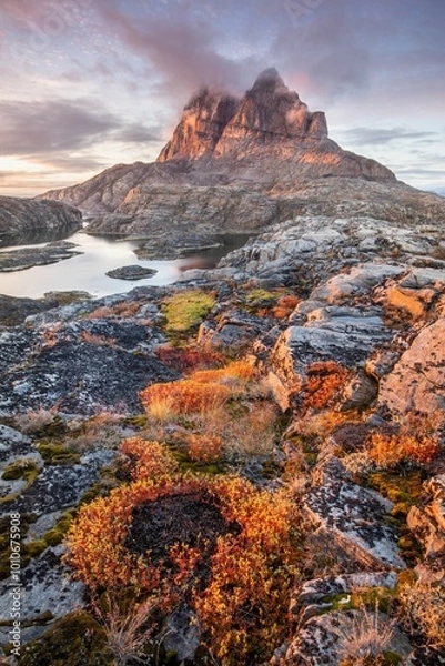 Fototapeta Mountains and lake in Uummannaq during summer time, Greenland. Located on an island. Beautiful arctic landscape. View of the Greenlandic island of Uummannaq with its distinctive rock.