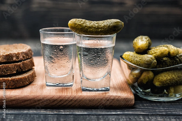 Fototapeta Russian vodka in small glass with black bread and pickles