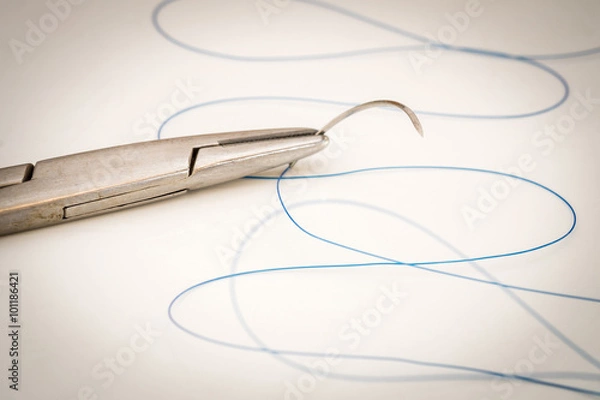 Obraz Close up of needle holder with suture and needle