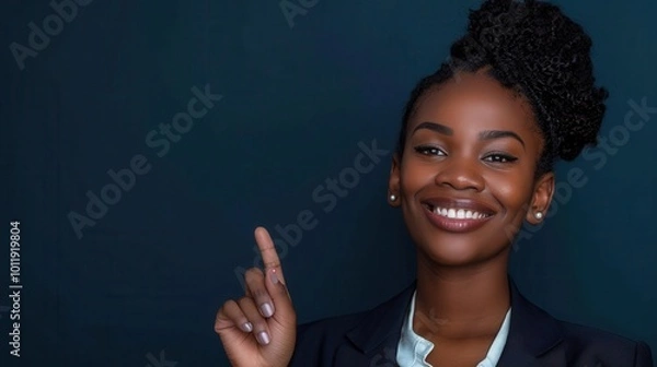 Fototapeta Confident Black Businesswoman Pointing Upwards With a Smile