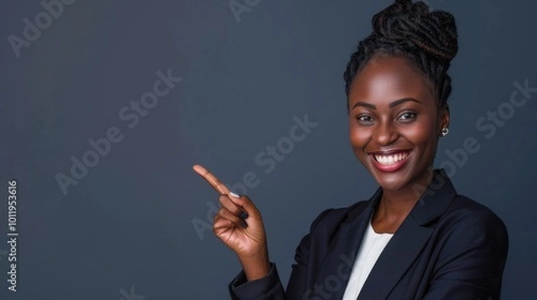 Fototapeta Confident Black Businesswoman Smiling and Pointing Against Gray Background