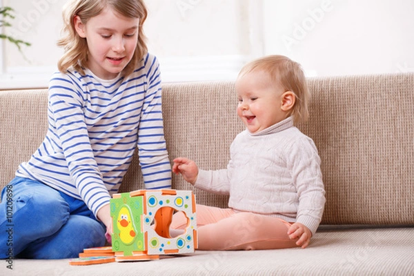 Fototapeta two sisters playing educational games