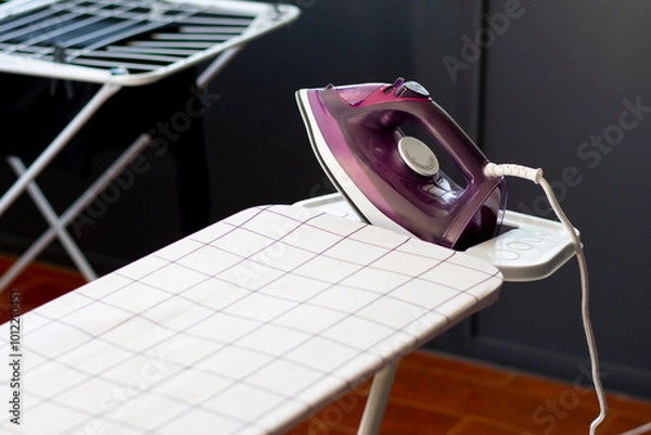 Fototapeta iron appliance with an ironing table ready to clean the clothes