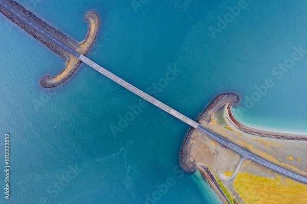 Fototapeta Icelant, travel destination in europe. Aerial vertical view by drone. Screen saver background abstract pattern of Sword Bridge.  Beautiful lines and colors.