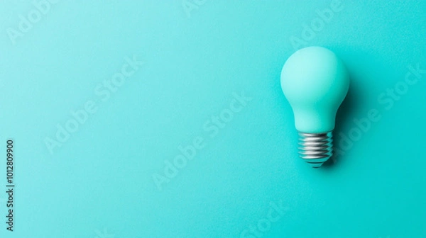 Fototapeta glowing light bulb symbolizes innovation and ideas, illuminating a clean background. This image represents creativity, inspiration, and the bright potential of new thoughts and solutions