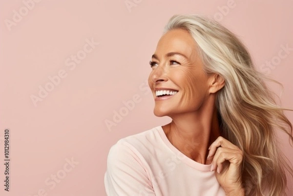 Obraz Portrait of a happy smiling middle aged woman, over pink background