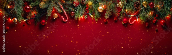 Fototapeta Fir branches with Christmas balls on glittering red background with winter holiday lights