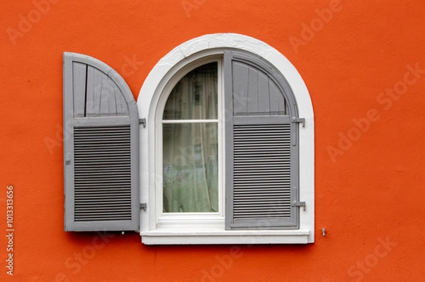 Obraz White and grey round window over orange wall