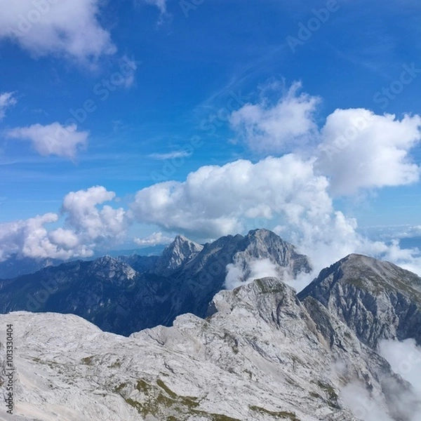 Obraz epic mountain peaks with cloudy background