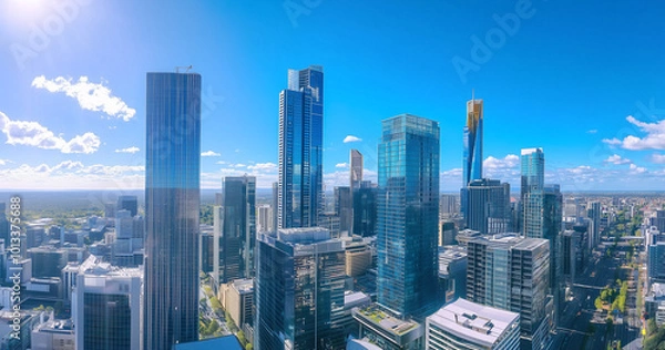 Fototapeta Aerial View of City Skyline and Skyscrapers Under Blue Sky and White Clouds