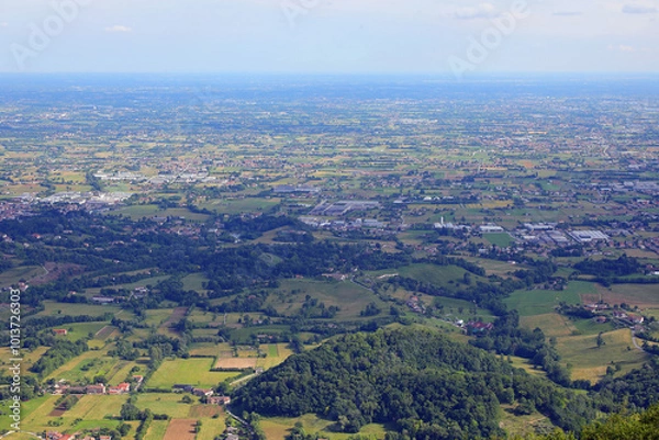 Fototapeta view from above of the italian plain called po valley with city houses and fields