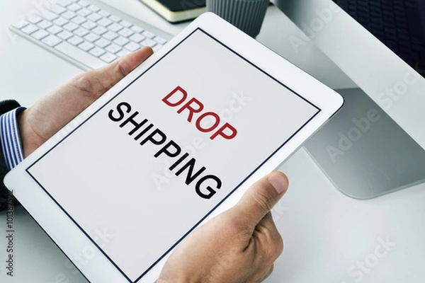 Fototapeta businessman with a tablet with the text drop shipping