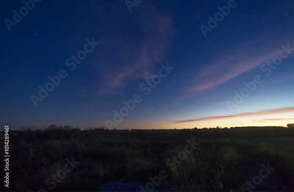 Obraz Sunset over a farms field