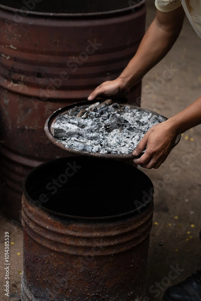 Fototapeta Hand holding firewood with rustic oven
