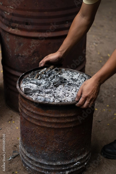 Obraz Hand holding firewood with rustic oven