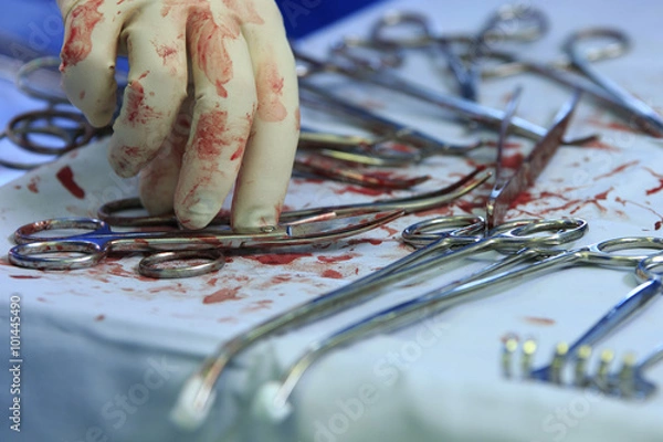 Obraz Surgeon's hand and bloody tools