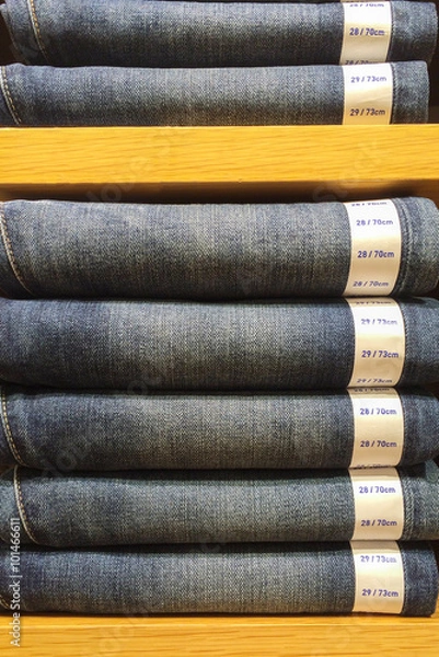 Fototapeta Mix Size of Classic Blue Jeans Texture with Paper Tag Exhibit on Wooden Shelf Showcase used as Template