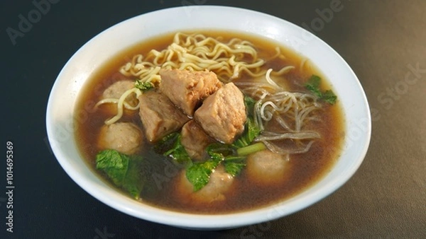Fototapeta a typical Indonesian food called Bakso or Baso in a bowl on a black background