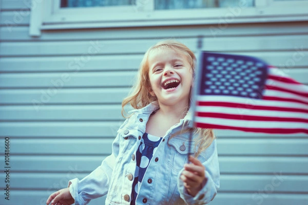 Obraz Cute little girl with long curly blond hair laughing and waving american flag. Independence Day, Flag Day concept. Vintage and retro toning