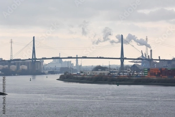 Fototapeta An winter impression of the port of Hamburg with the Elbe and the Köhlbrand Bridge.