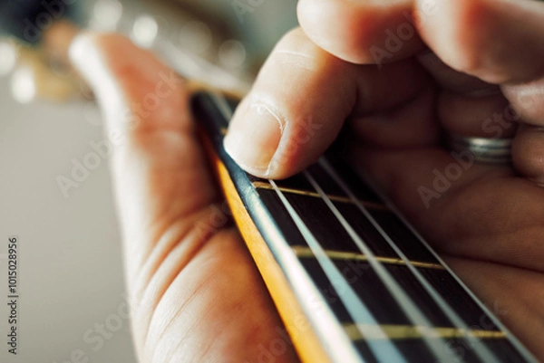Obraz close up of human hand playing Ukulele