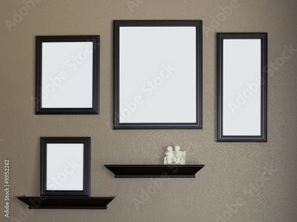 Obraz Four black blank picture frames against a brown wall