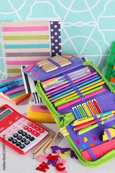 Fototapeta Pencil case with various stationery on wooden table, close up