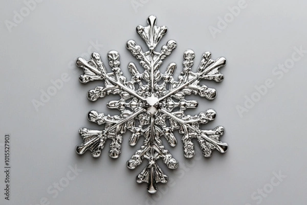 Fototapeta Silver Snowflake Ornament: A captivating close-up of an ornate silver snowflake ornament, perfect for adding a touch of winter elegance to your designs.