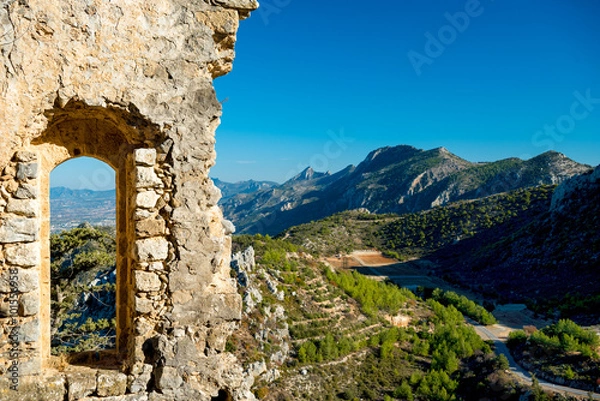 Fototapeta Ruined castle window with a mountain view