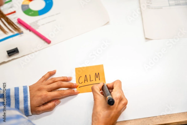 Obraz Hands of a woman writing notes on post-it