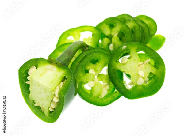 Fototapeta Sliced jalapeño peppers isolated on a white background with a large chunk in the with stem attached.