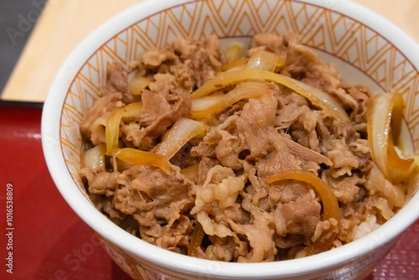 Fototapeta Gyudon (Japanese Beef & Rice Bowls),  is a savory donburi dish of thin pieces of tender fatty beef, onions, and a sauce of mirin and soy, served over rice