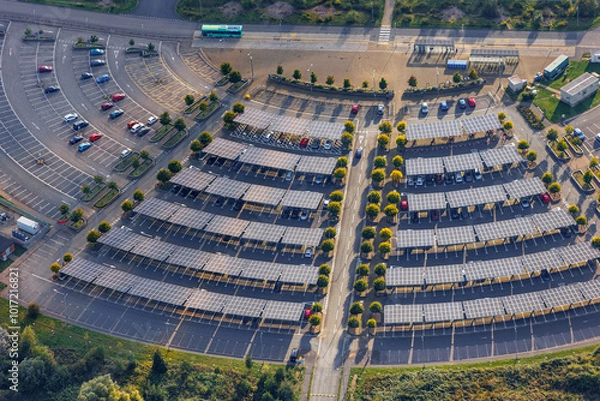 Obraz Aerial view of UK park and ride with solar roof panels, promoting sustainable urban transit solutions.