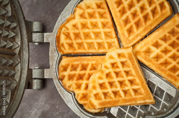 Obraz Home made heart shaped waffles served in a traditional cast iron waffle pan.