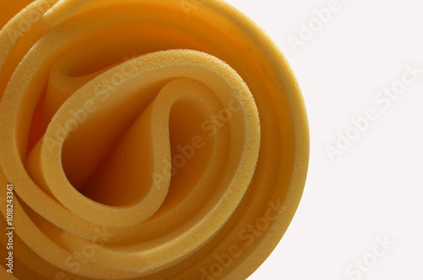 Fototapeta a bundle of rolled dark yellow thin sponge foam material isolated on a white background