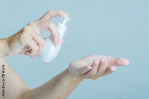Obraz Hands Applying Skincare Product with Pump Bottle