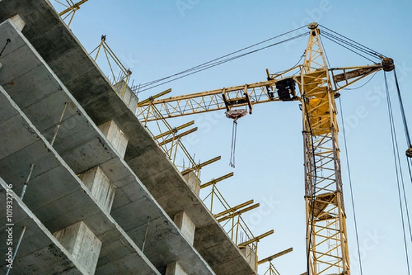 Obraz Building under construction and crane.