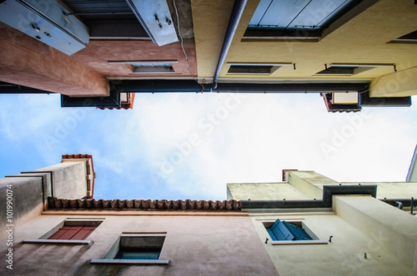 Fototapeta Street view with channels and houses in Chioggia
